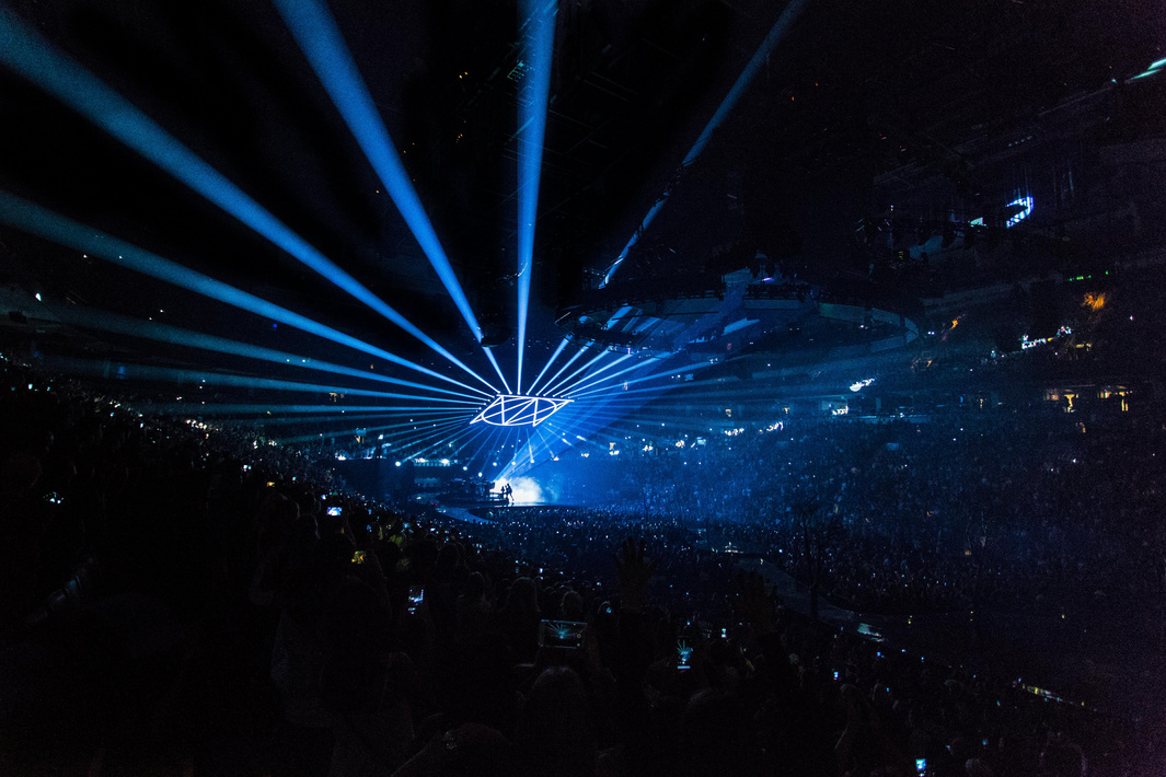 People on Arena With Lighted Stage